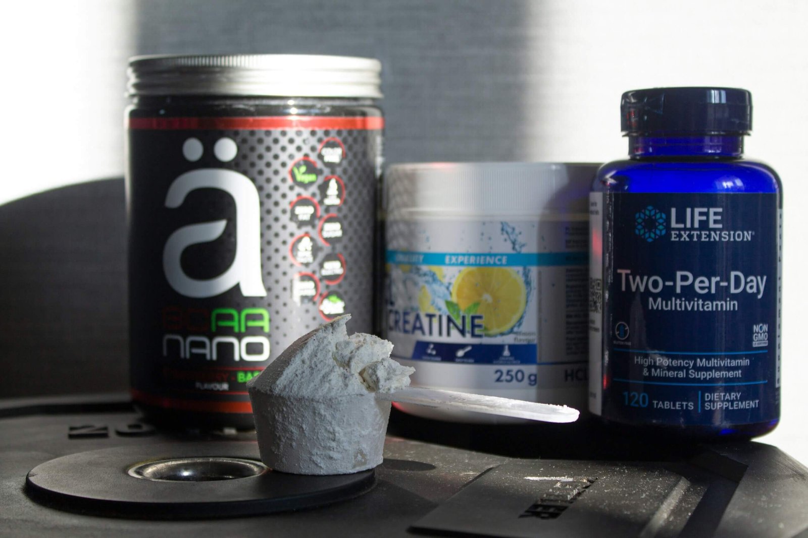 Supplement containers and a scoop of powder