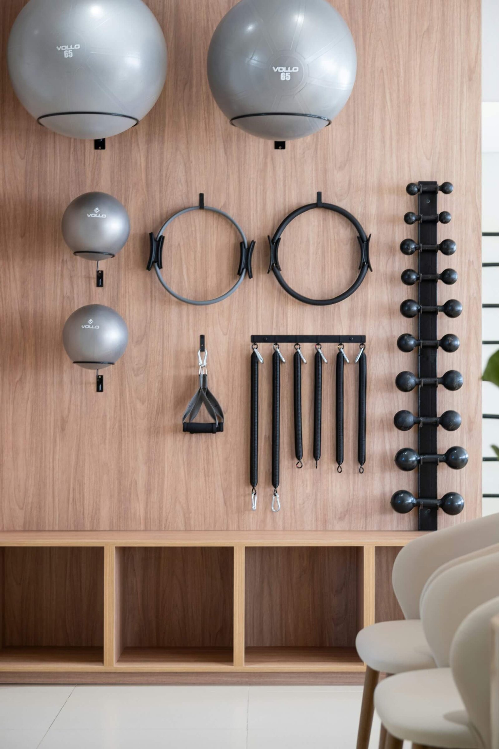 Exercise balls, Pilates rings and dumbbells on a gym wall